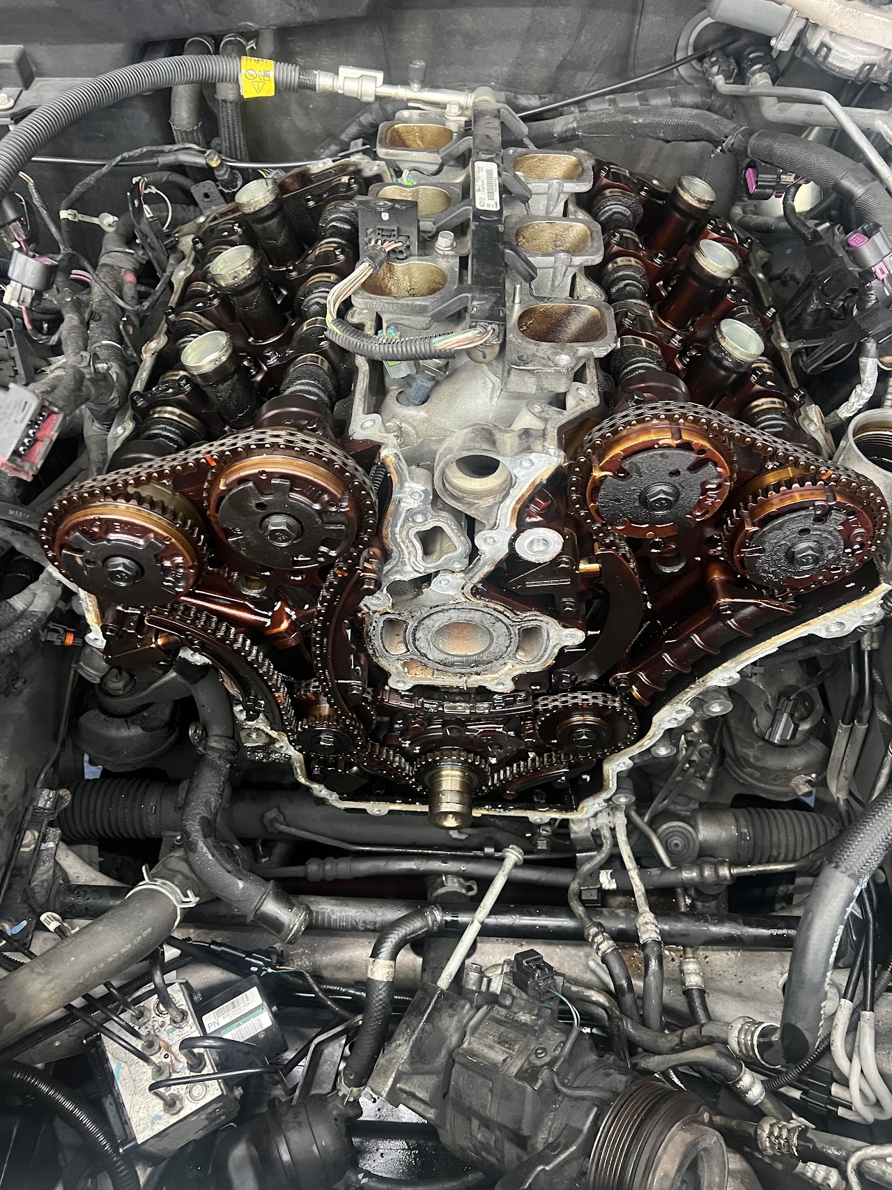 Close-up engine timing chain repair at Rubens Auto Service
